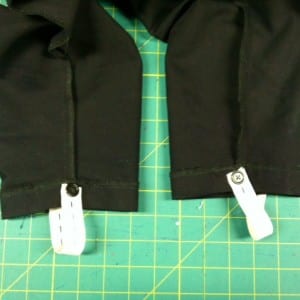 Black pants with stirrups attached on the inside.