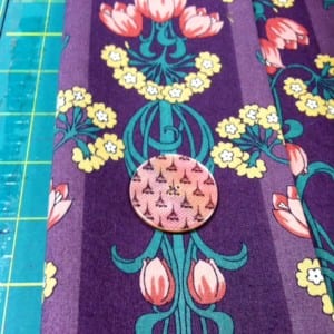 Testing the button on the art deco fabric