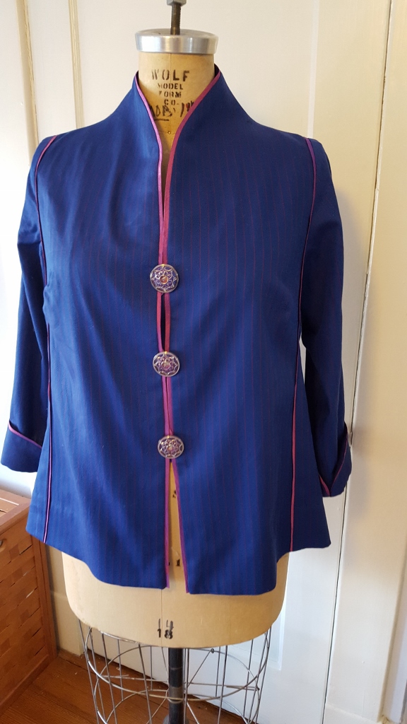 Blue silk shirt with pink trim.