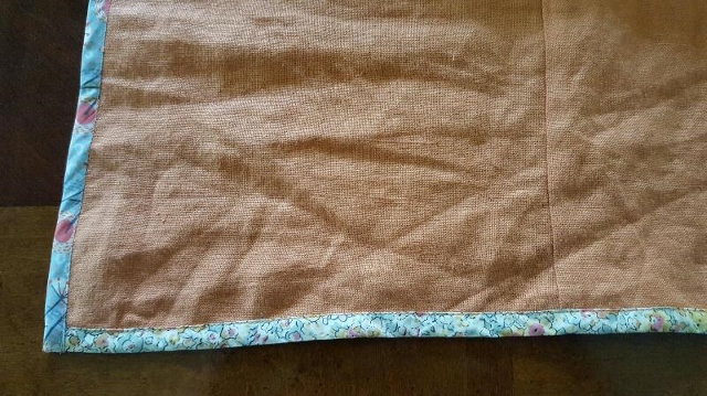 Right side of the orange linen with bound hem.