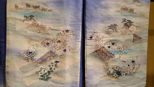 A pair of delicately painted and embroidered sleeves.