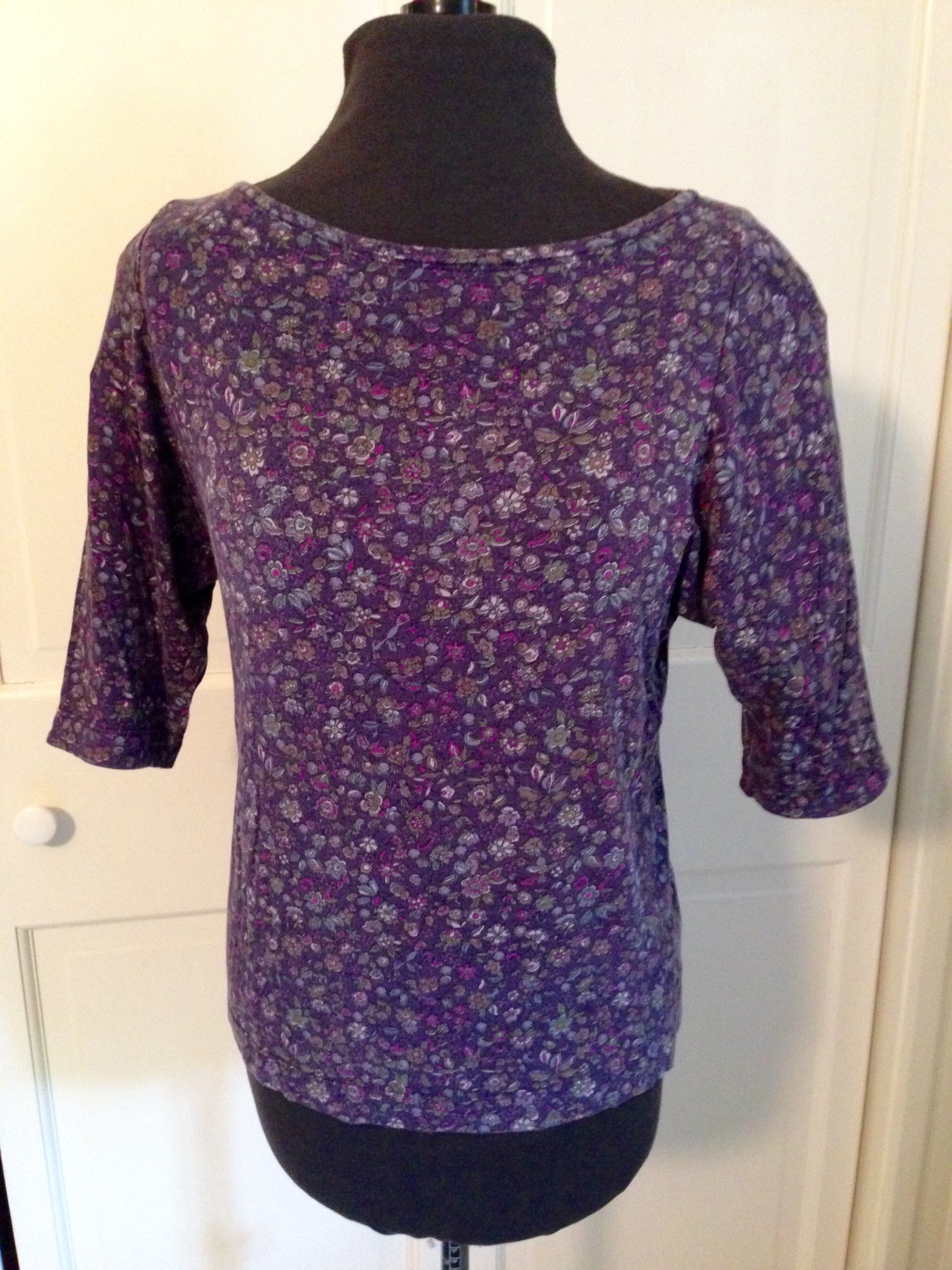 Tee with cover stitched neckline and hems at both sleeves and bottom.